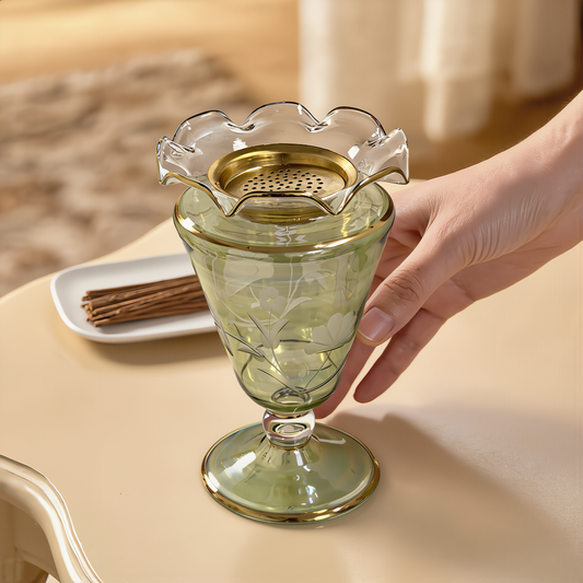 Hand holding a green Egyptian glass vase with a gold ruffled rim
