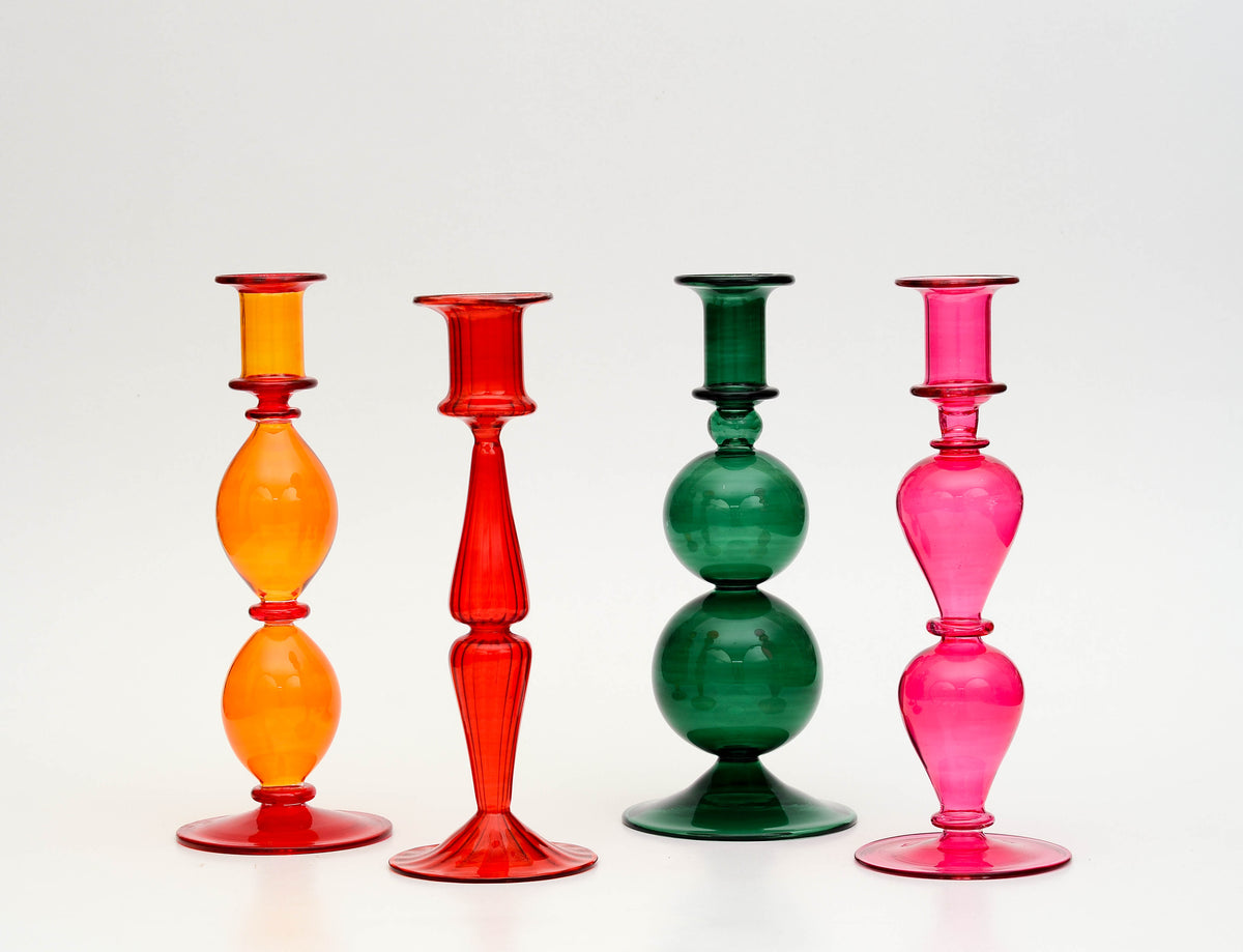 Vivid set of four coloured glass candlesticks in orange, red, emerald and fuchsia