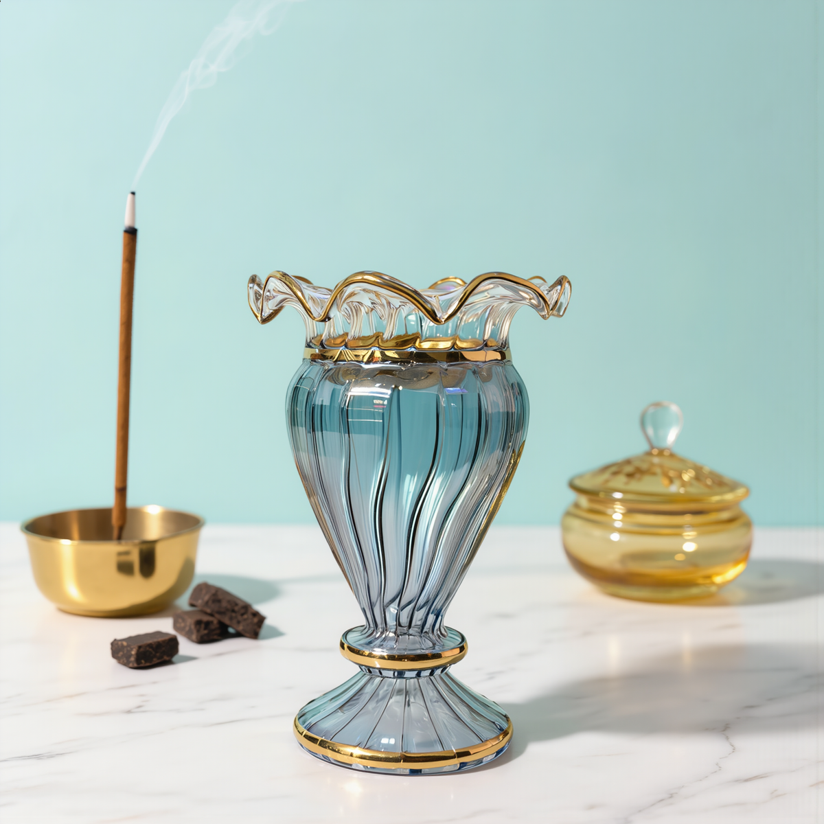 Blue Egyptian glass mabkhara with a gold ruffled rim and gilded pedestal foot