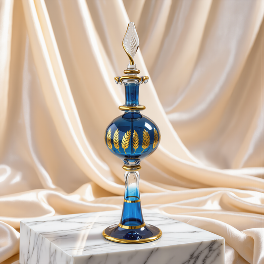 Mini blue Egyptian glass perfume bottle with gold work on ivory satin drape