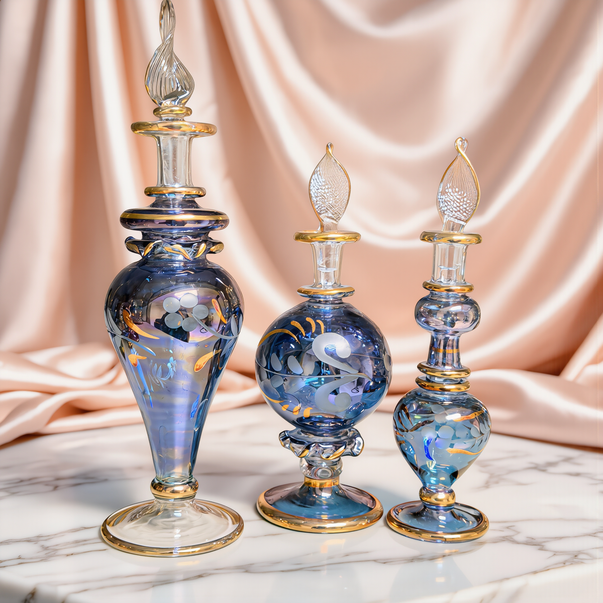 Round blue Egyptian glass bottle with gold decoration on ivory satin